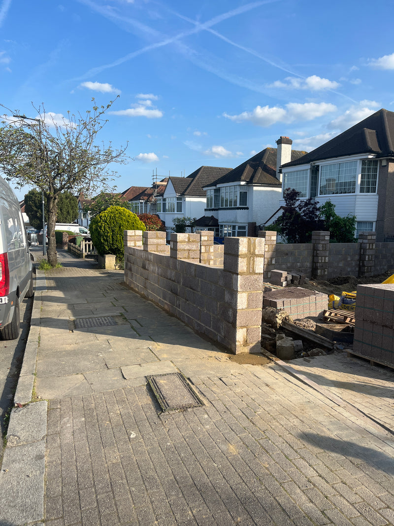 Construction of a new front garden boundary wall for a London home, featuring structural pillars and decorative blockwork to enhance curb appeal.