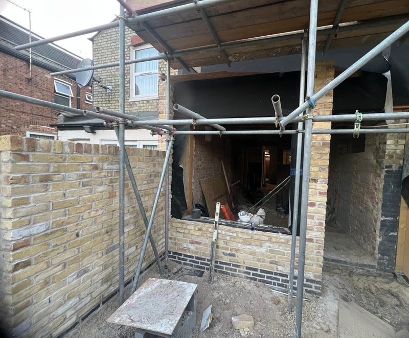 A detailed view of a newly constructed red brick wall with fresh mortar joints. The image highlights the clean, uniform pointing and precise brick alignment characteristic of Brobrick Construction’s masonry work in London.
