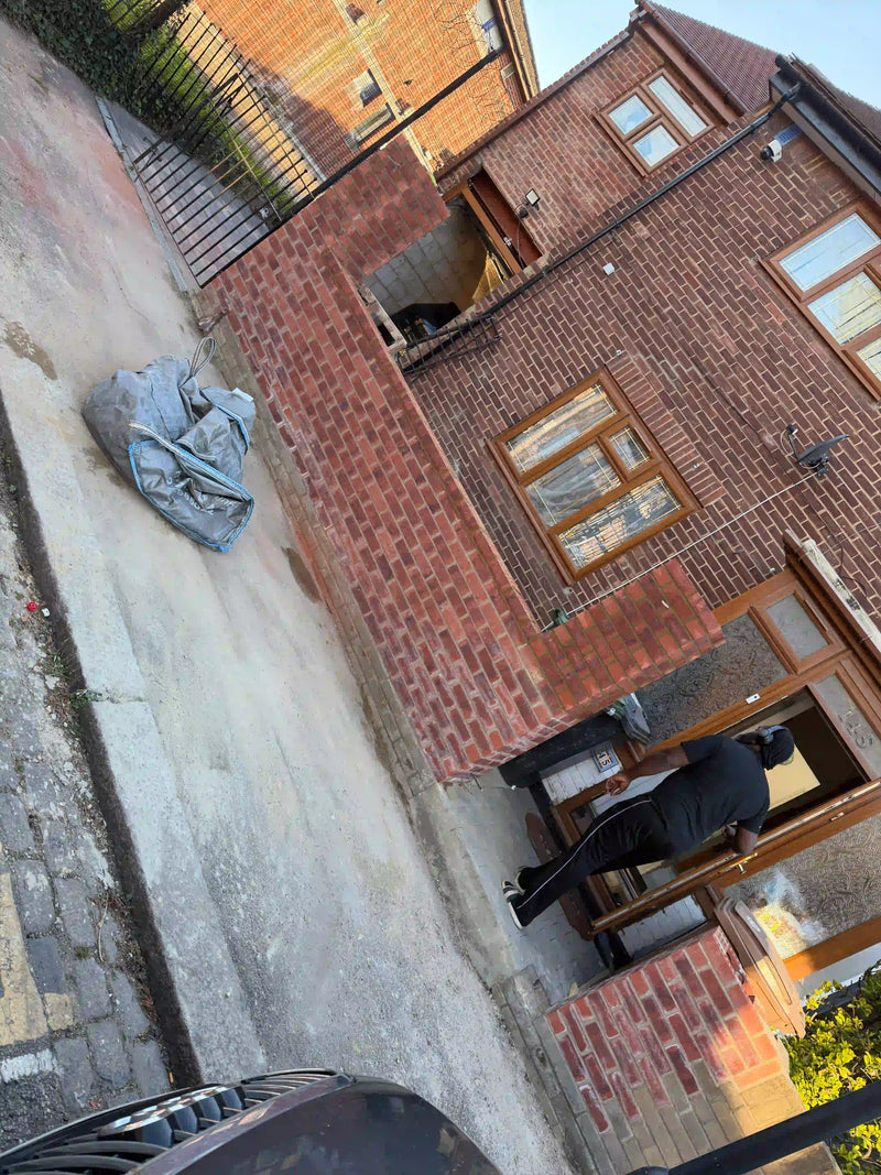 Completed red brick side return extension on a London terraced house, showing clean brickwork, timber-framed windows, and integration with the existing property. Built by Brobrick Construction Ltd.